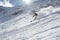 skier descending powdery slope on a sunny day