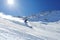 skier descending powdery slope on a sunny day