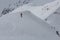 skier descends a steep frozen slope in the mountains