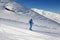 Skier downhill on snowy ski slope at nice sun day