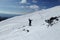 Skier dressed in black and blue. Free rider jumping on the mountain slope on the background of wonderful Chopok, Low Tatras in