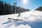 Skier falling on the slope on fresh powder snow at winter resort.