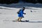 Skier going down the slopes on hi-speed at sunny day