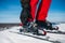 Skier hand fastens the fastening of skis closeup