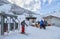 A skier has passed a turnstile for boarding onto a chair ski lift in Gorky Gorod winter mountain ski resort. Skiers queue up for a