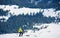 Skier hiker with backpack on skis in deep white snow on background of beautiful winter landscape.