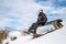 Skier hiker have a rest on bench during winter forest hiking