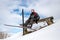 Skier hiker relaxing on bench during winter forest skiing