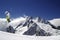 Skier jump with crossed skis in high snowy mountains