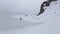 Skier jump from springboard, make stunt in air. Grey weather. Ski resort. Sport