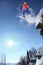 Skier jumping against blue sky