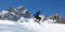 Skier jumping in front of rock mountains Meribel sun snowy mountain landscape France alpes 3 vallees