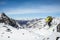 Skier jumping off a boulder above Snowbird Glacier in the backcountry of the Talkeetna Mountains in remote Alaska