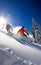 Skier jumping in the snow mountains on the slope with his ski and professional equipment on a sunny day