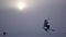 Skier on kite making various tricks, flying over the frozen lake, 4k