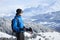 Skier looking at Alps mountains landscape with beautiful snow covered forest in the valley near Chamonix Mont Blanc, France