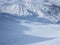 Skier making fresh tracks in the untouched snow down a valley