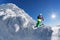 Skier on monoski in high mountains against blue sky