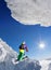 Skier on monoski in high mountains against blue sky