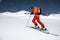 A skier in an orange suit skis in a mountain off-piste skiing in the northern caucasus of Mount Elbrus