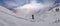 A skier on the piste in front of beautiful mountains