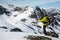 Skier pointing to long couloir ski route in teh Talkeetna Mountains of Alaska