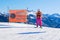 Skier posing in a race style position next to a ski piste sign saying Difficult Slope in German, Italian, and English