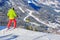 Skier preparing to drop into a red ski run above La Villa village, South Tyrol, in Dolomites, Italy