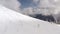 Skier riding freeride on ski from snowy slope in winter mountain aerial view