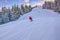 Skier running down the slope in Karakol mountains.