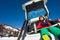 Skier sitting in car boot and drinking warm tea