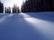 A skier on a ski slope in early morning