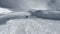 Skier Skiing Down Mountainside On Skis On Sunny Winter Day At Snow Mountain