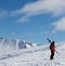 Skier with skis on his shoulder in nice sun day. Caucasus Mountains in winter, Georgia, region Gudauri