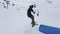 Skier slide on springboard at ski resort in mountains. Extreme flip. Ski lifts. People. Challenge