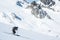 Skier sliding down steep slope overlooking the Snowbird Glacier in the Talkeetna Mountains of Alaska