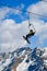 Skier and snowboarder on chairlift at Pejo Ski Resort in Val di Sole valley, Italy. Europe.