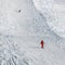 Skier and snowboarder downhill on snowy ski slope at sun winter