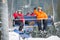 Skier and snowboarder riding up on ski lift