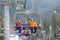 Skier and snowboarder riding up on ski lift