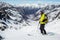 Skier standing above Snowbird Glacier looking down Bartholf Creek in Talkeetna Mountains