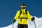 Skier standing on a slope. Man in a light suit, the helmet and mask in skiing is to ski. In the background snow-capped