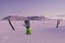 Skier stretching out his snow covered hand next to trekking poles to signal help because of snow avalanche . Danger extreme