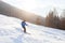 Skier in sunset mountains, downhill skiing