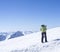 Skier at the top of Schaufelspitze mountain at Stubai Gletscher ski resort preparing to go down into the valley. Snow