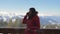 Skier On The Veranda In The Chalet Talking On The Smartphone In The Winter