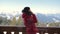 Skier On The Veranda In The Chalet Talking On The Smartphone In The Winter