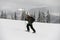 skier walking on ski along snowy trail with backpack. Ski touring