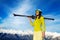 Skier woman in light clothes over sky