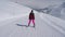 Skier Woman Slowly Skiing Down On Ski Slope In Mountain